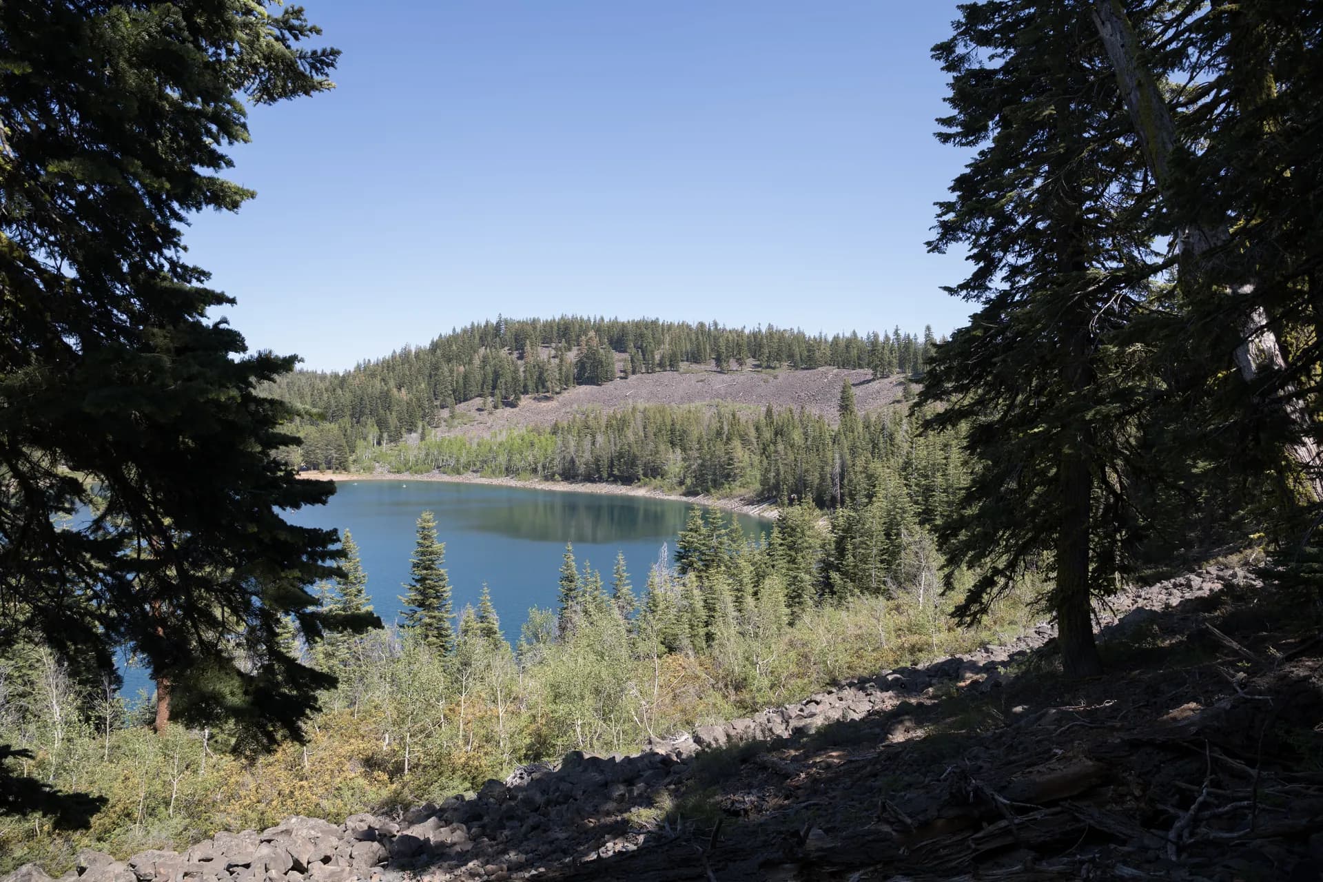 Crater Lake surrounded by conifer forest in Lassen National Forest, northeastern California